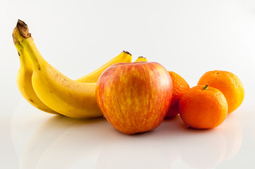 Fototapeta na wymiar Banana, apple and tangerine