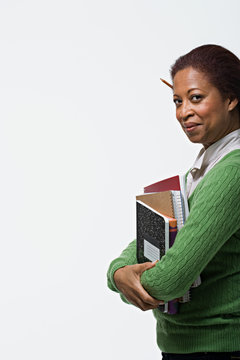 Portrait of teacher holding books