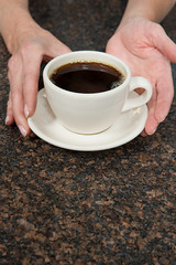 Person holding coffee cup