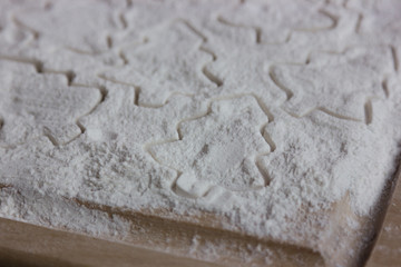 form for christmas cookies on flour
