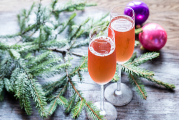 Two glasses of champagne with Christmas tree branch