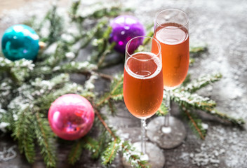 Two glasses of champagne with Christmas tree branch