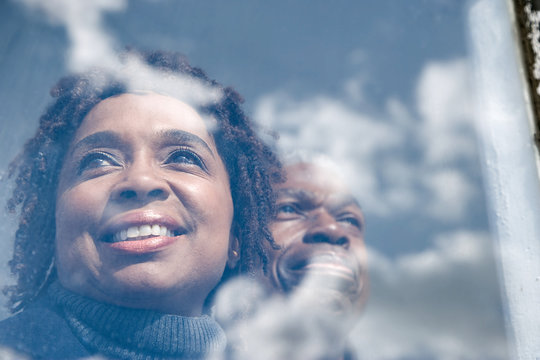 Couple Looking Out Of A Window