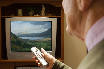 Senior man watching television