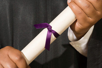 Graduate holding diploma