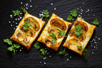 Mini mushroom tarts with puff pastry . Delicious vegetarian appetizer - obrazy, fototapety, plakaty