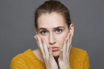doubt and confusion concept - portrait of nervous beautiful 20s girl expressing anxiety and...