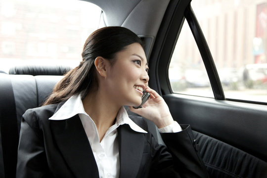 Businesswoman In A Car On The Phone