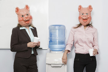 Two businesswoman in pig masks at a water cooler