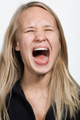 Portrait of young Caucasian woman screaming