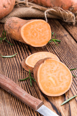 Sweet Potato (uncooked) on wooden background