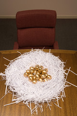 Fototapeta na wymiar Golden eggs in a paper nest