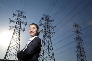 Businesswoman in front of power lines