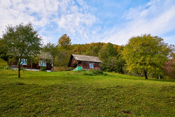 Mountain country village landscape with clouds and blue sky