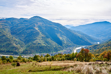 Mountain country village landscape with clouds and blue sky