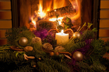Christmas table decoration in front of fireplace.