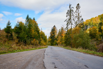 Mountain road lanscape with clouds and colorful trees