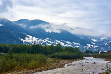 Mountain river in foggy rainy weather