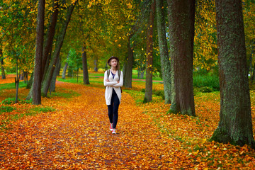 Romantic girl dreams. Pleasure of freedom. Autumn mood in park.