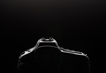 Professional modern DSLR camera low key image