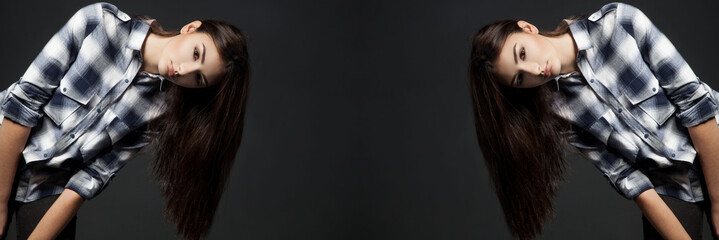 Young pretty woman looking at camera over grey background.