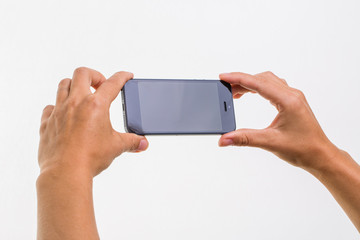 Female hand holding a smart phone, isolated on white