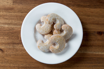 Christmas sweet rolls on brown wooden background.