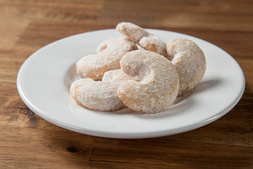 Christmas sweet rolls on brown wooden background.