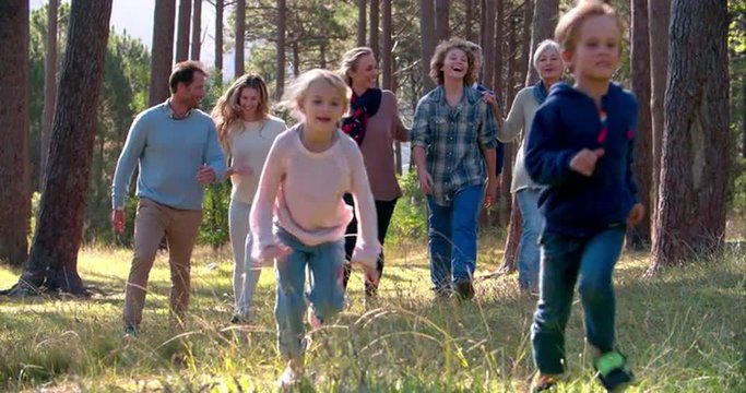 Multi generation family with kids running in nature