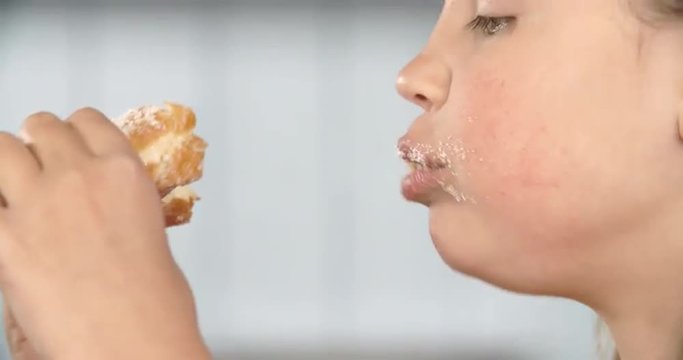 Close Up Of Girl Eating Sugary Donut