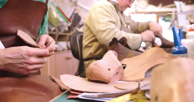 Bespoke Shoemaker Measuring And Cutting Leather For Shoe 