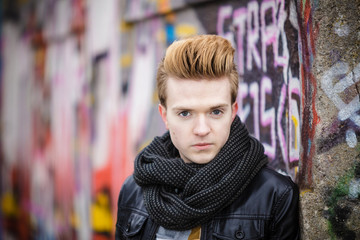 Obraz premium Fashion male portrait on graffiti wall