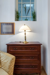 Detail room, dresser and table lamp