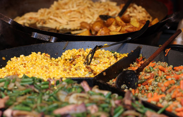 Cooking corn on pan on christmas market