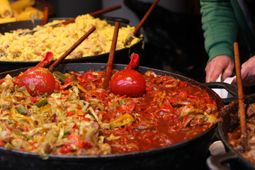 Cooking  meal  in great pan on christmas market