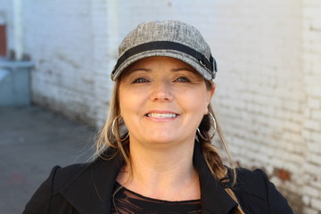 Close up Happy Adult Woman with Long Blond Hair and a hat, Laughing While Walking at the City Street 