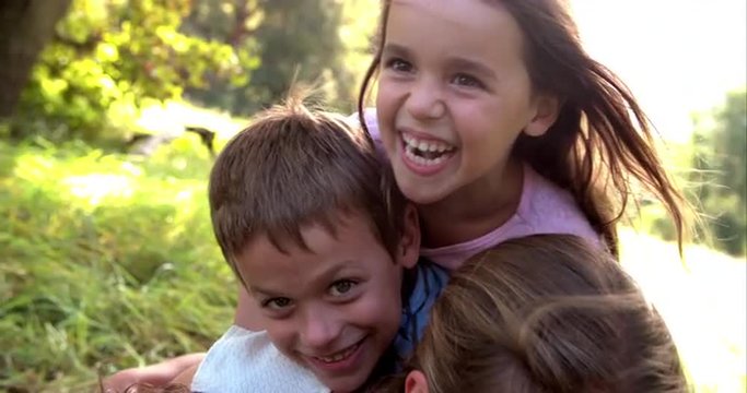 Young couple and kids having fun together outdoors