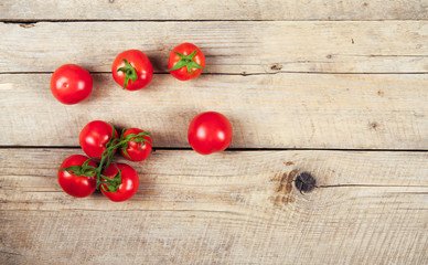 Fresh cherry tomatoes on rustic wooden background