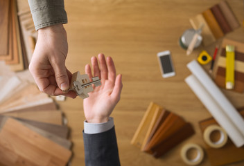 Real estate agent giving house keys