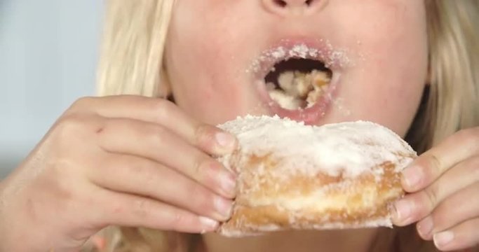 Close Up Of Girl Eating Sugary Donut
