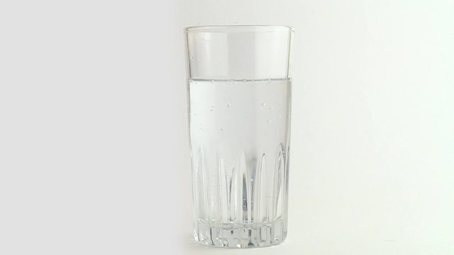 sparkling water in glass on a white background