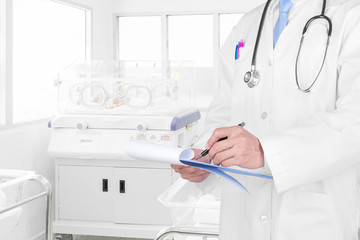 Doctor writing a medical prescription with medical background