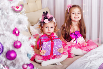 Obraz na płótnie Canvas Two girls with gifts for Christmas.
