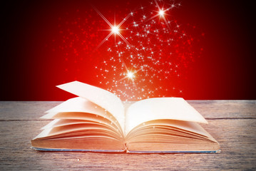 Abstract red magic book on wooden background