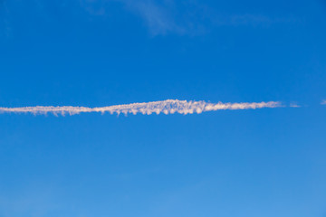 abstract contrail cloud on the blue sky
