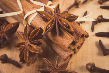 Vintage photo, Star anise, cinnamon sticks and cloves on wooden table, seasoning for cooking