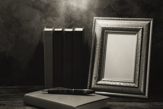 still life of picture frame on table with diary book