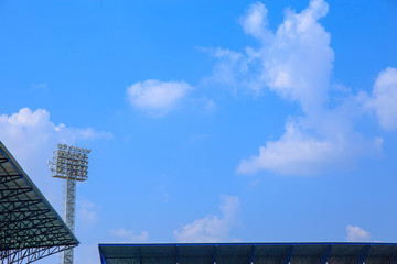 Fototapeta premium Lighting tower of stadium on sky and cloud background.