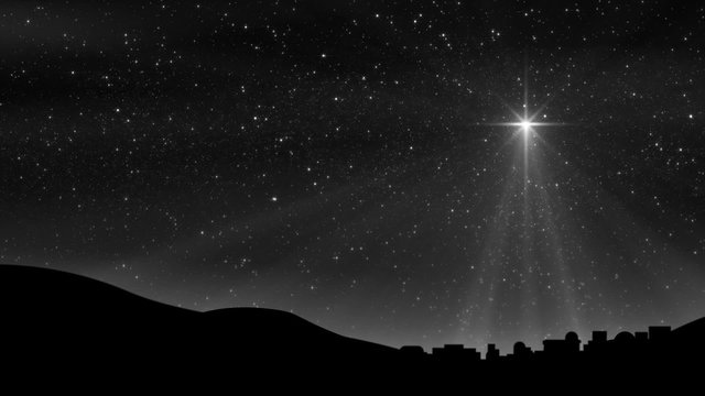 A large Christmas Nativity Star shines down on Bethlehem silhouetted by a dark cloudy motion background sky. Loop is perfectly seamless (no fade).