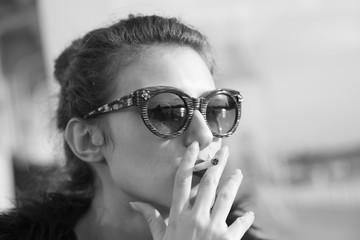 Beautiful girl portrait in retro style smoking the cigarette black and white photography